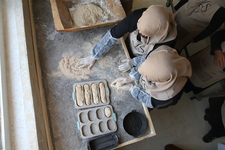 In the heart of Anatolia, a 3,500-year-old culinary tradition has been brought back to life. Inspired by cuneiform tablets unearthed in the ancient Hittite capital of Hattusa (modern-day Boğazkale), a women's cooperative in the Turkish province of Çorum has successfully recreated "Hittite bread" using organic, pre-industrial methods. Led by agricultural engineer Tuba Topkara, the Valide Sultanlar Sofrası Women’s Cooperative has revived this Bronze Age staple through a blend of experimental archaeology, gastronomy, and traditional craftsmanship. The initiative, launched in collaboration with culinary historian and teacher Ülkü Menşure Solak, brings a tangible piece of Hittite heritage into modern kitchens. A Recipe from the Tablets The inspiration for the project comes from Hittite ritual and temple texts, many of which contain detailed references to ceremonial foods — including specific types of bread. Solak, co-author of the 2007 book “Hittite Cuisine as Experimental Archaeology,” helped interpret these ancient texts and guided the reproduction of the bread according to historical clues. To achieve authenticity, Topkara and her team cultivated heirloom wheat with local farmers, milled it in a stone grinder, and mixed it with natural spring water, wild yeast, and rock salt. The dough was hand-kneaded in wooden troughs and baked in a renovated wood-fired stone oven, a structure the women restored specifically for this purpose. “This bread carries the memory of an empire,” said Topkara. “Every ingredient, every step of the process respects the spirit of the Hittites. It's not just food — it’s cultural revival.” From Ritual to Reality The Hittites, one of the great Bronze Age civilizations of the Near East, ruled much of Anatolia between 1600–1200 BCE. Their archives, inscribed on thousands of clay tablets, include not only treaties and legal codes but also religious rituals and food preparations — providing rare insight into daily and ceremonial life. Experimental archaeologist Solak emphasized the importance of method: “The bread had to be fully organic. It had to be milled by stone, fired by oak wood, and shaped by hand — just as the Hittites would have done 3,500 years ago.” Today, the bread is offered to the public through Çorum Municipality’s cultural centers and is already drawing interest from culinary tourism groups and food historians alike. Heritage with a Future The cooperative’s goal is not just to recreate a taste of the past but to position Hittite bread as a symbol of sustainable food culture. With a growing global interest in ancient grains, pre-industrial baking techniques, and women-led food heritage initiatives, the project has already sparked inquiries from researchers and chefs across Europe and Asia. “We want to share this story with the world,” said Topkara. “Hittite bread belongs not just to the past, but to the future of cultural gastronomy.”