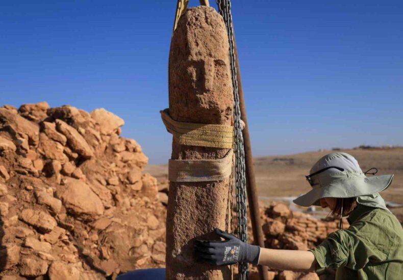 Archaeologists have uncovered a T-shaped pillar carved with a human face at the Neolithic site of Karahantepe in southeastern Türkiye — a discovery described as a first in human history. The finding was announced by Minister of Culture and Tourism Mehmet Nuri Ersoy on his official X (Twitter) account, where he wrote: “Karahantepe — A first in history! Within the scope of our Taş Tepeler Project, a T-shaped pillar with a human face has been unearthed for the first time.” The discovery forms part of the Taş Tepeler (Stone Hills) Project, a long-term archaeological initiative led by the Turkish Ministry of Culture and Tourism, which explores the earliest stages of human settlement and symbolic expression in the Şanlıurfa region. A Turning Point in Neolithic Symbolism For decades, the T-shaped pillars of Göbeklitepe and Karahantepe have been interpreted as stylized human figures, primarily due to the carved arms and hands visible on many examples. Yet, this new pillar — the first to bear a carved human face — marks a major leap in understanding how early Neolithic societies perceived themselves. The pillar’s face, featuring deep-set eyes, a pronounced nose, and sharp contours, resembles other human sculptures from Karahantepe. Experts say the find reflects not only the craftsmanship of early Anatolian communities but also their emerging capacity for abstract and self-referential thought. From Symbol to Identity Until now, these T-shaped monoliths were thought to serve either as structural elements or abstract human representations. The new find, however, provides the first direct depiction of the human visage, offering a rare glimpse into the earliest stages of self-image in human history. Karahantepe and the Taş Tepeler Network Dating back approximately 12,000 years, Karahantepe is one of several interconnected sites in the Taş Tepeler region, which also includes Göbeklitepe, Sefertepe, Sayburç, Harbetsuvan Tepesi, and Çakmaktepe. These settlements continue to reshape our understanding of humanity’s transition from nomadic life to organized, temple-centered communities. Together, they position Anatolia as one of the earliest centers of symbolic architecture and spiritual innovation.