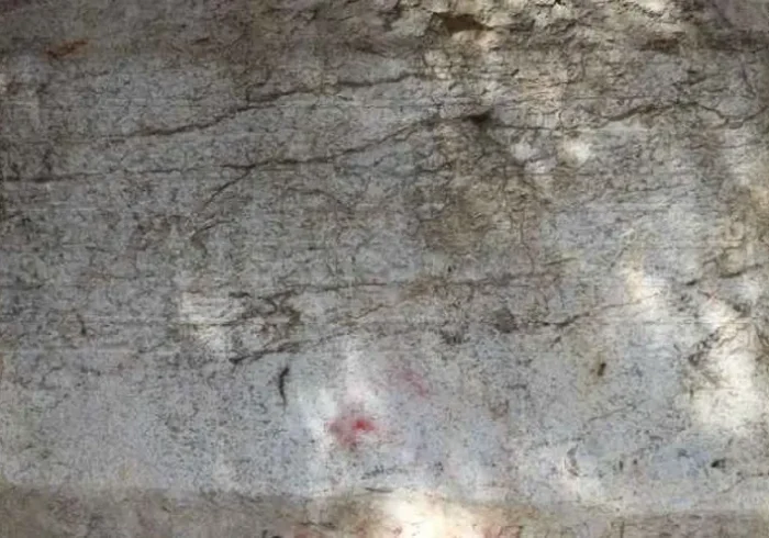 A 600-year-old Ottoman endowment inscription carved directly into natural bedrock has been restored in Amasya, northern Türkiye. Dating to 1418, the Bayezid Pasha foundation text is now readable again after years of damage, and experts say it may represent the only known example of a waqf inscription carved into living rock anywhere in the world. Located along the banks of the Yeşilırmak River, near the Leğenkaya Waterfall, the inscription had long been obscured by graffiti and surface deterioration. The recent restoration has not only cleaned the stone but also revealed a rare form of Ottoman documentation—one that was literally engraved into the landscape. A waqf text carved into living rock Commissioned by Grand Vizier Bayezid Pasha during the reign of Ottoman Sultan Mehmed I, the inscription differs fundamentally from typical waqf documents. Instead of being written on paper or carved onto a separate stone slab, the text was engraved directly into the natural rock surface. Before carving began, the rock face was carefully leveled to create a smooth plane resembling polished marble. The inscription, executed in relief, spans approximately 3 meters in width and 110 centimeters in height. It consists of eight lines in Arabic script and contains around 125 words, excluding particles. This deliberate and permanent method of inscription suggests a strong intention to embed the legal and charitable framework of the foundation into the physical environment itself. From vandalized surface to readable text Over time, the inscription suffered significant damage. Spray paint, scratches, and informal markings had turned the surface into what locals described as a “writing board,” obscuring much of the original text. The restoration process involved carefully removing paint residues using a controlled micro-abrasion technique with travertine powder. The weakened stone surface was then stabilized with compatible conservation materials. To improve legibility, conservators applied subtle shading, allowing the carved letters to stand out more clearly without altering the original structure. As a result, the inscription has regained much of its visual clarity. Protected for the future The intervention went beyond cleaning and stabilization. A reinforced protection system was installed around the site, including structural supports and a transparent protective layer over the inscription itself. Lighting was also added to enhance nighttime visibility, ensuring the inscription can be appreciated while remaining protected from further environmental and human damage. Why this inscription matters Waqf (endowment) documents played a central role in the Ottoman world, defining how religious, social, and charitable institutions were funded and maintained. These texts were typically recorded in manuscripts or occasionally inscribed on architectural elements. The Amasya example stands apart. By carving the endowment directly into bedrock, its creators transformed a legal document into a permanent public statement embedded in the natural landscape. According to regional heritage officials, this characteristic may make it the only known rock-cut waqf inscription of its kind globally—a claim that, if further supported, would place the monument in a unique position within both Ottoman studies and the broader history of epigraphy.