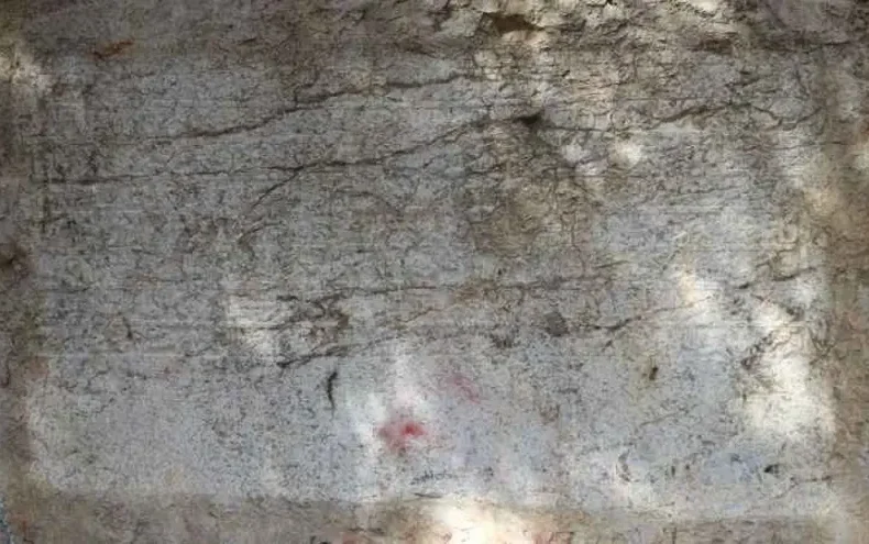 A 600-year-old Ottoman endowment inscription carved directly into natural bedrock has been restored in Amasya, northern Türkiye. Dating to 1418, the Bayezid Pasha foundation text is now readable again after years of damage, and experts say it may represent the only known example of a waqf inscription carved into living rock anywhere in the world. Located along the banks of the Yeşilırmak River, near the Leğenkaya Waterfall, the inscription had long been obscured by graffiti and surface deterioration. The recent restoration has not only cleaned the stone but also revealed a rare form of Ottoman documentation—one that was literally engraved into the landscape. A waqf text carved into living rock Commissioned by Grand Vizier Bayezid Pasha during the reign of Ottoman Sultan Mehmed I, the inscription differs fundamentally from typical waqf documents. Instead of being written on paper or carved onto a separate stone slab, the text was engraved directly into the natural rock surface. Before carving began, the rock face was carefully leveled to create a smooth plane resembling polished marble. The inscription, executed in relief, spans approximately 3 meters in width and 110 centimeters in height. It consists of eight lines in Arabic script and contains around 125 words, excluding particles. This deliberate and permanent method of inscription suggests a strong intention to embed the legal and charitable framework of the foundation into the physical environment itself. From vandalized surface to readable text Over time, the inscription suffered significant damage. Spray paint, scratches, and informal markings had turned the surface into what locals described as a “writing board,” obscuring much of the original text. The restoration process involved carefully removing paint residues using a controlled micro-abrasion technique with travertine powder. The weakened stone surface was then stabilized with compatible conservation materials. To improve legibility, conservators applied subtle shading, allowing the carved letters to stand out more clearly without altering the original structure. As a result, the inscription has regained much of its visual clarity. Protected for the future The intervention went beyond cleaning and stabilization. A reinforced protection system was installed around the site, including structural supports and a transparent protective layer over the inscription itself. Lighting was also added to enhance nighttime visibility, ensuring the inscription can be appreciated while remaining protected from further environmental and human damage. Why this inscription matters Waqf (endowment) documents played a central role in the Ottoman world, defining how religious, social, and charitable institutions were funded and maintained. These texts were typically recorded in manuscripts or occasionally inscribed on architectural elements. The Amasya example stands apart. By carving the endowment directly into bedrock, its creators transformed a legal document into a permanent public statement embedded in the natural landscape. According to regional heritage officials, this characteristic may make it the only known rock-cut waqf inscription of its kind globally—a claim that, if further supported, would place the monument in a unique position within both Ottoman studies and the broader history of epigraphy.