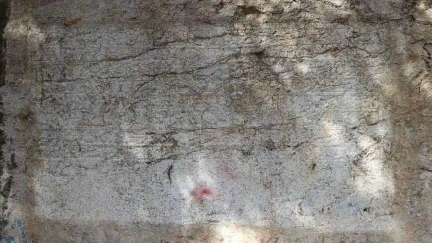 A 600-year-old Ottoman endowment inscription carved directly into natural bedrock has been restored in Amasya, northern Türkiye. Dating to 1418, the Bayezid Pasha foundation text is now readable again after years of damage, and experts say it may represent the only known example of a waqf inscription carved into living rock anywhere in the world. Located along the banks of the Yeşilırmak River, near the Leğenkaya Waterfall, the inscription had long been obscured by graffiti and surface deterioration. The recent restoration has not only cleaned the stone but also revealed a rare form of Ottoman documentation—one that was literally engraved into the landscape. A waqf text carved into living rock Commissioned by Grand Vizier Bayezid Pasha during the reign of Ottoman Sultan Mehmed I, the inscription differs fundamentally from typical waqf documents. Instead of being written on paper or carved onto a separate stone slab, the text was engraved directly into the natural rock surface. Before carving began, the rock face was carefully leveled to create a smooth plane resembling polished marble. The inscription, executed in relief, spans approximately 3 meters in width and 110 centimeters in height. It consists of eight lines in Arabic script and contains around 125 words, excluding particles. This deliberate and permanent method of inscription suggests a strong intention to embed the legal and charitable framework of the foundation into the physical environment itself. From vandalized surface to readable text Over time, the inscription suffered significant damage. Spray paint, scratches, and informal markings had turned the surface into what locals described as a “writing board,” obscuring much of the original text. The restoration process involved carefully removing paint residues using a controlled micro-abrasion technique with travertine powder. The weakened stone surface was then stabilized with compatible conservation materials. To improve legibility, conservators applied subtle shading, allowing the carved letters to stand out more clearly without altering the original structure. As a result, the inscription has regained much of its visual clarity. Protected for the future The intervention went beyond cleaning and stabilization. A reinforced protection system was installed around the site, including structural supports and a transparent protective layer over the inscription itself. Lighting was also added to enhance nighttime visibility, ensuring the inscription can be appreciated while remaining protected from further environmental and human damage. Why this inscription matters Waqf (endowment) documents played a central role in the Ottoman world, defining how religious, social, and charitable institutions were funded and maintained. These texts were typically recorded in manuscripts or occasionally inscribed on architectural elements. The Amasya example stands apart. By carving the endowment directly into bedrock, its creators transformed a legal document into a permanent public statement embedded in the natural landscape. According to regional heritage officials, this characteristic may make it the only known rock-cut waqf inscription of its kind globally—a claim that, if further supported, would place the monument in a unique position within both Ottoman studies and the broader history of epigraphy.